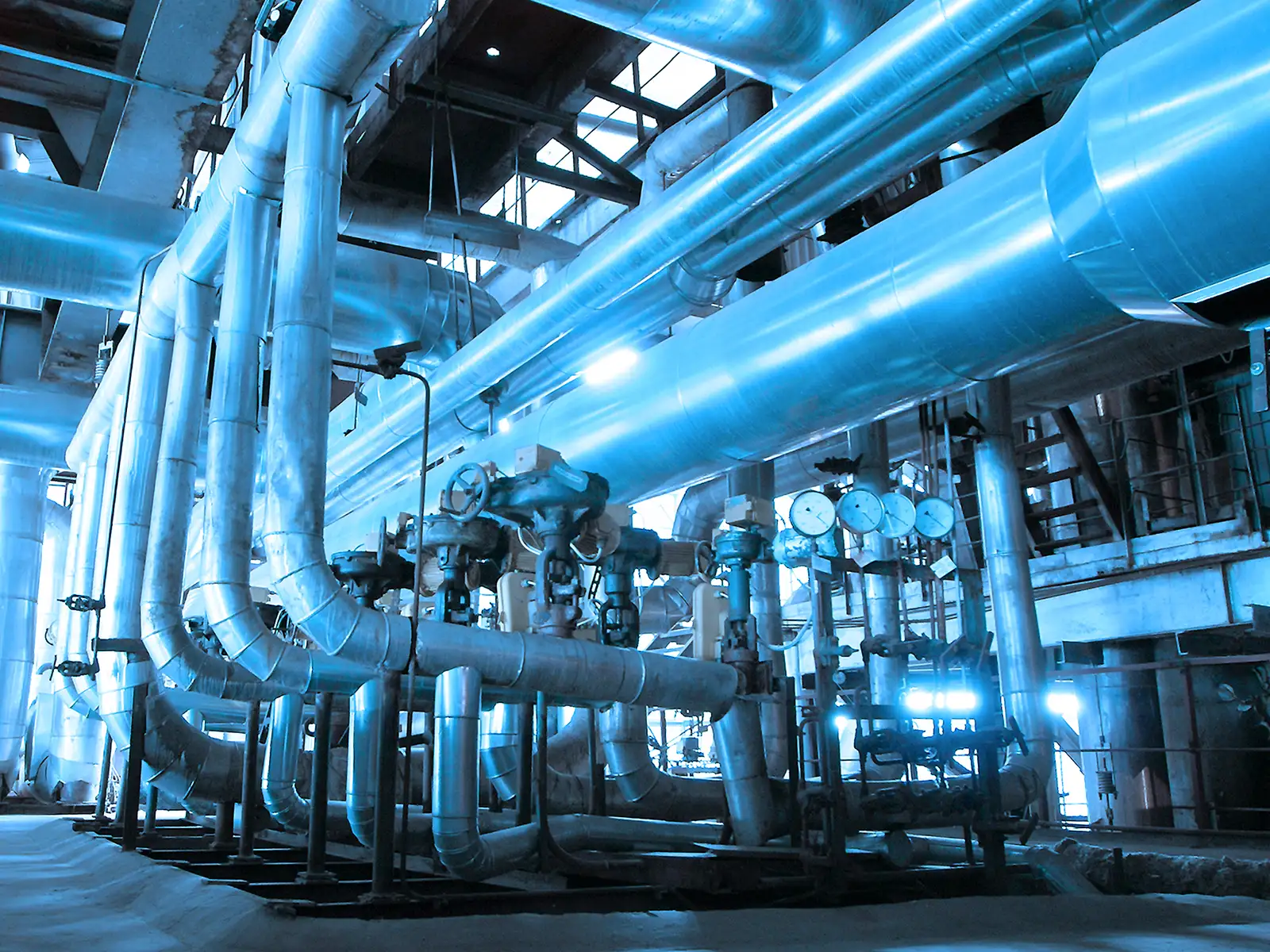 Image from inside a process facility showing pipes and different gauges.