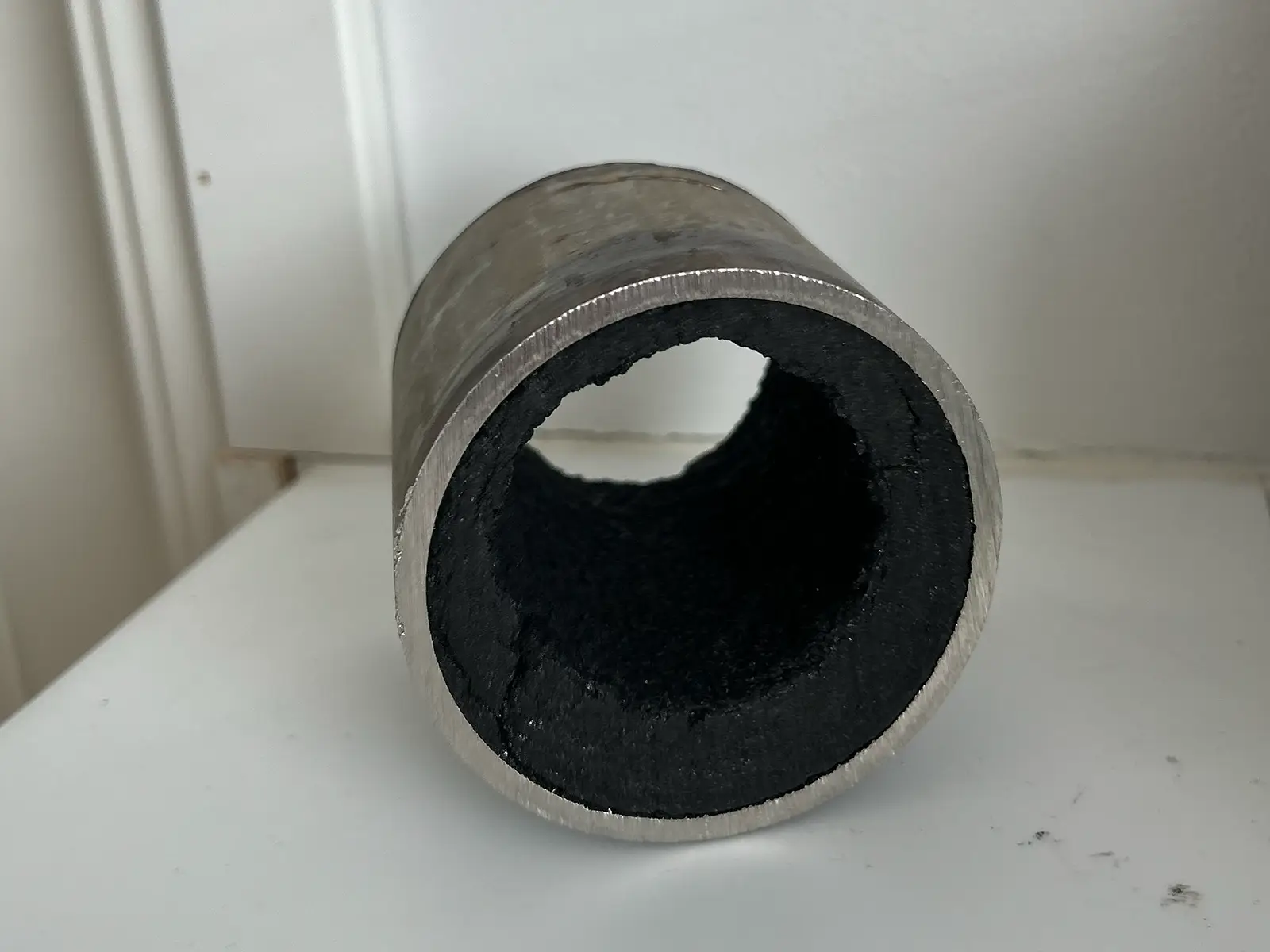 Thick layer of fouling on the inside of a pipe