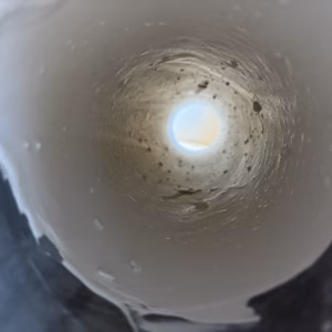 Scale buildup inside an industrial pipe highlighting the need for descaling